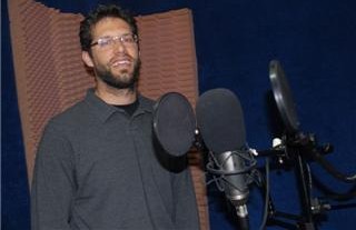 Santiago at the microphone where Radioclips are produced.